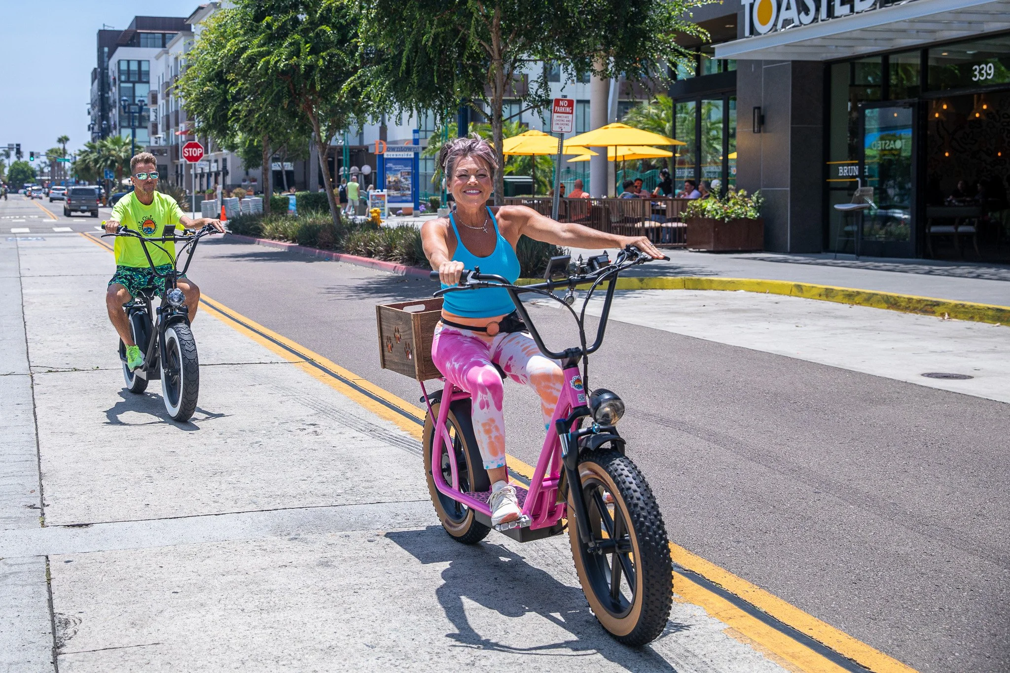 Two riders on Beachcomber electric scooters cruising along Oceanside beach | Ride Oside
