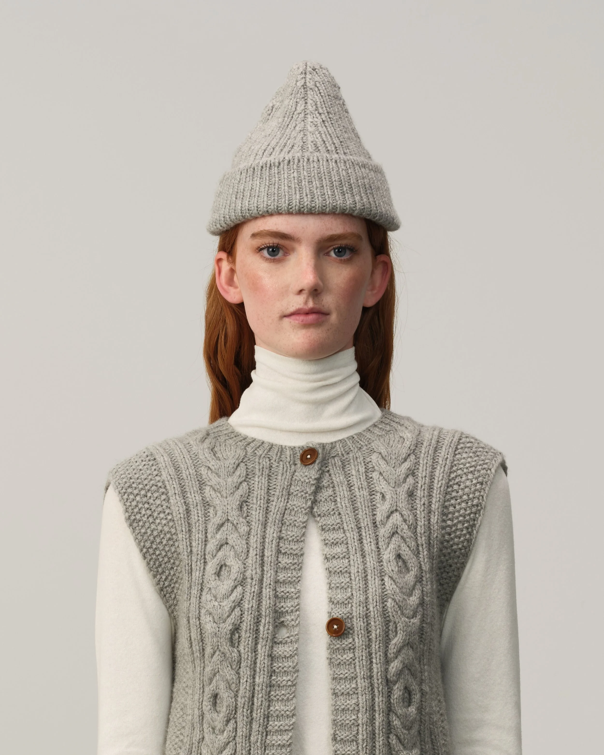 100% Peruvian Highland Wool Cabled Vest. Completely hand knit and fastened with sustainable palm nut (corozo) buttons, this is the perfect piece for the sometimes hot, sometimes cold of us.

Try it with the seed pearl necklace or matching toque!

Mad