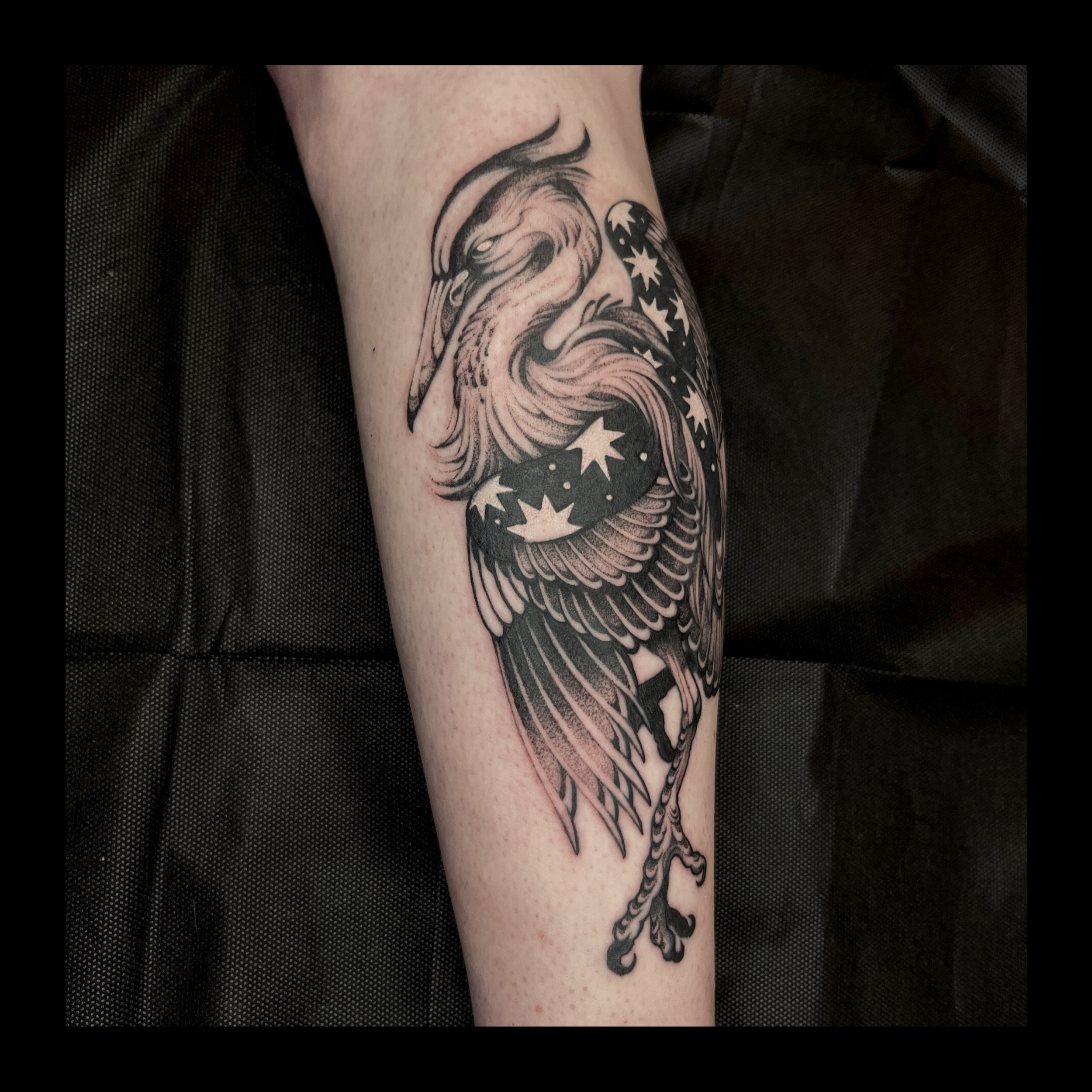 Tattoo of a wizard with a long beard, stars, and moon on a person's arm.
