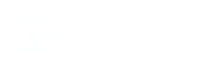 Logo for Homady & Corcoran Attorneys at Law featuring a scale of justice symbol.