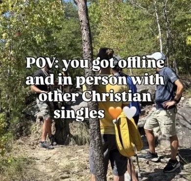 Group of people gathered outdoors in a wooded area, some with backpacks, engaging in conversation with a humorous overlay text about being offline and in-person with other Christian singles.