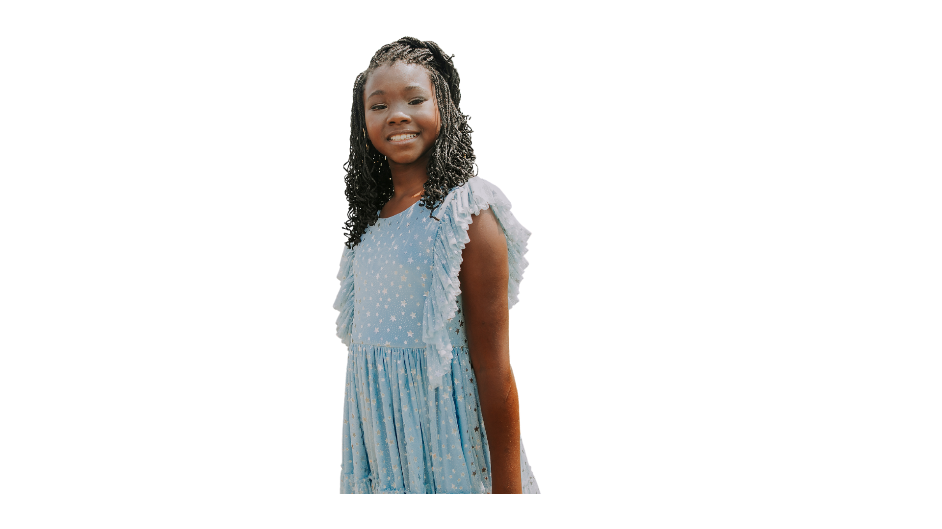 Young girl with curly hair wearing a blue dress with star patterns and ruffled sleeves, smiling at the camera.