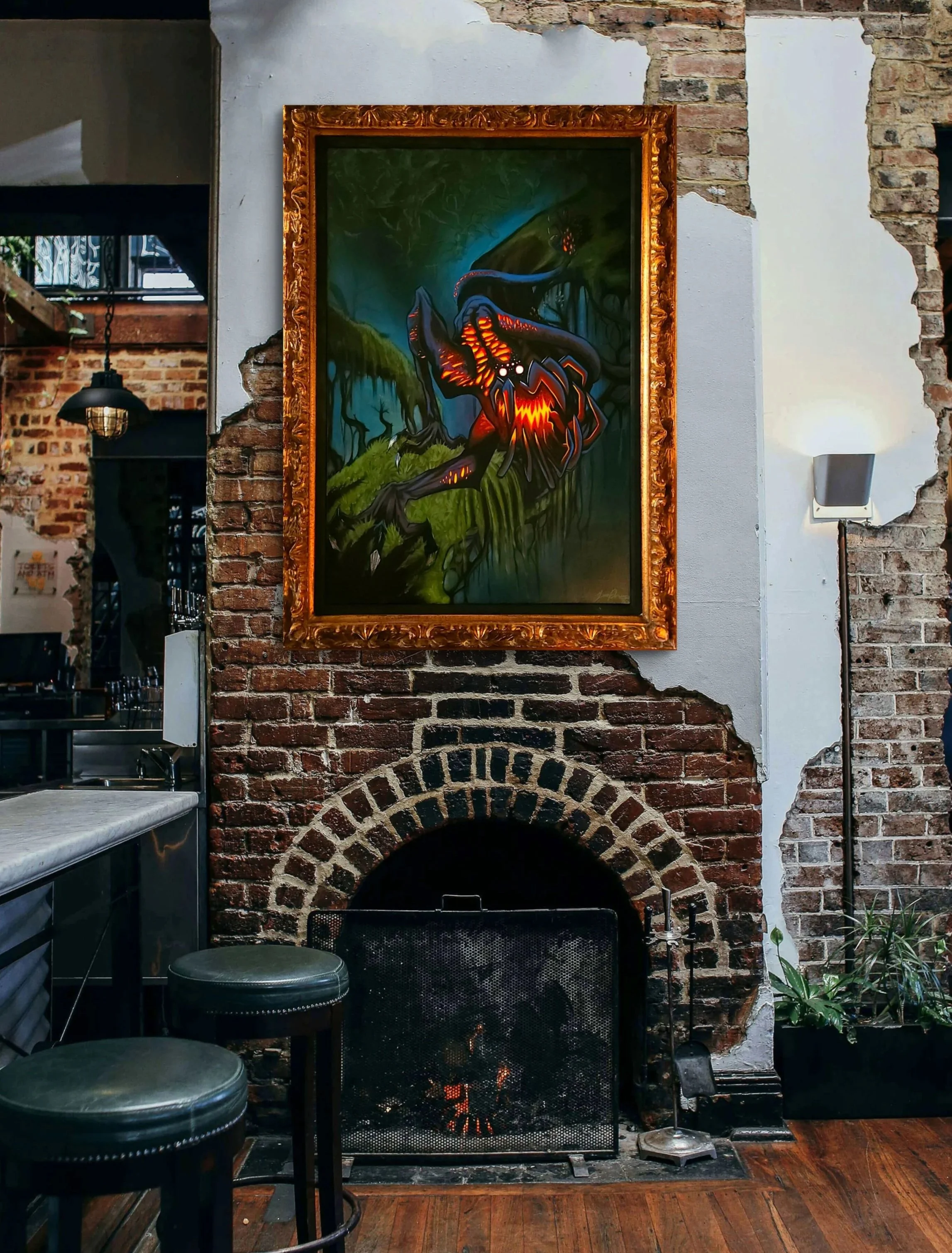 A painting of a dragon with glowing orange and yellow accents hanging above a brick fireplace in a rustic cafe or restaurant interior, with exposed brick and white painted walls, and wooden flooring.