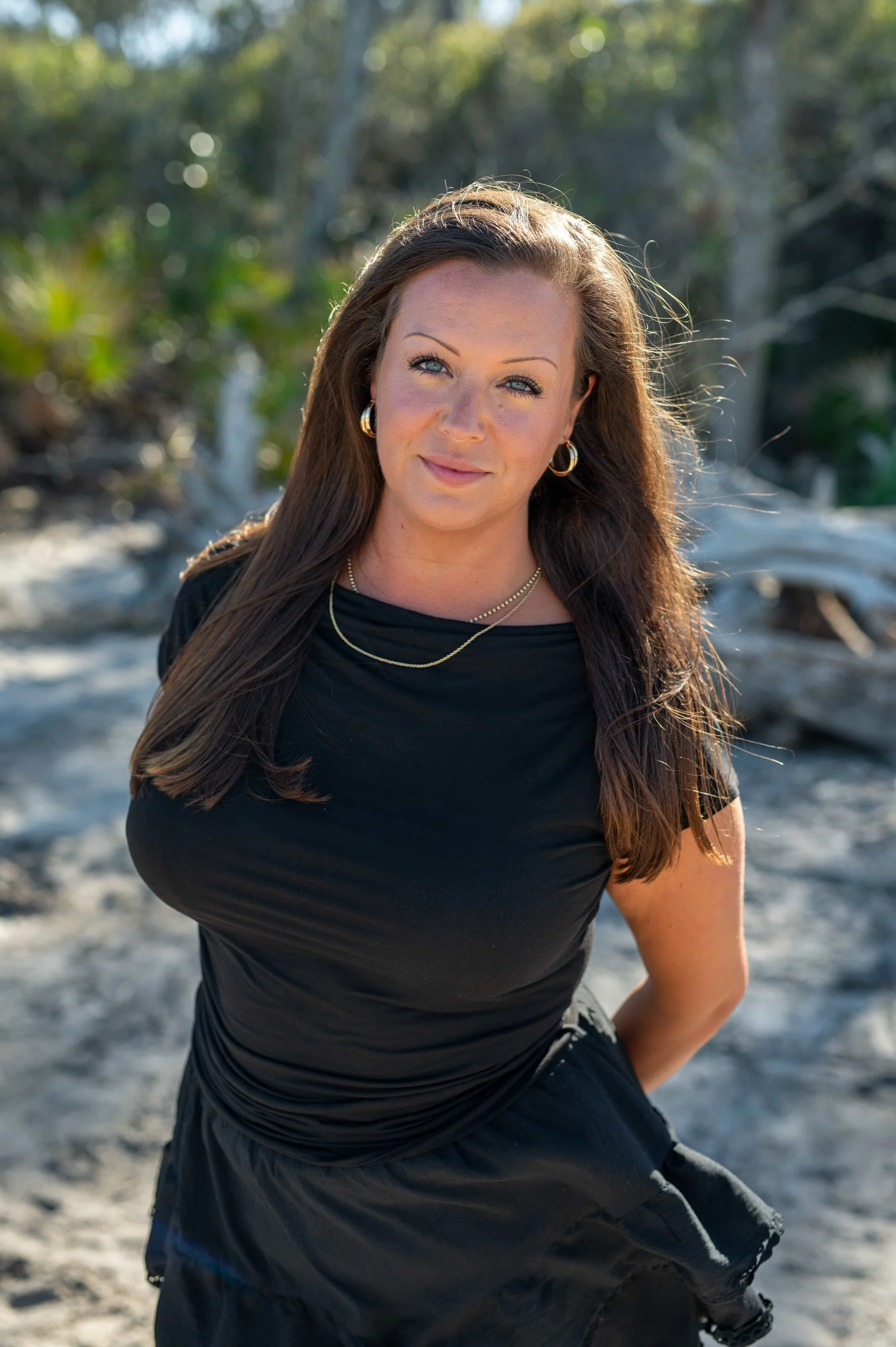 Jacquelynne Holmes, owner of LUXOM consulting, accounting services for established businesses. Image has blockstyle-border of royal blue.