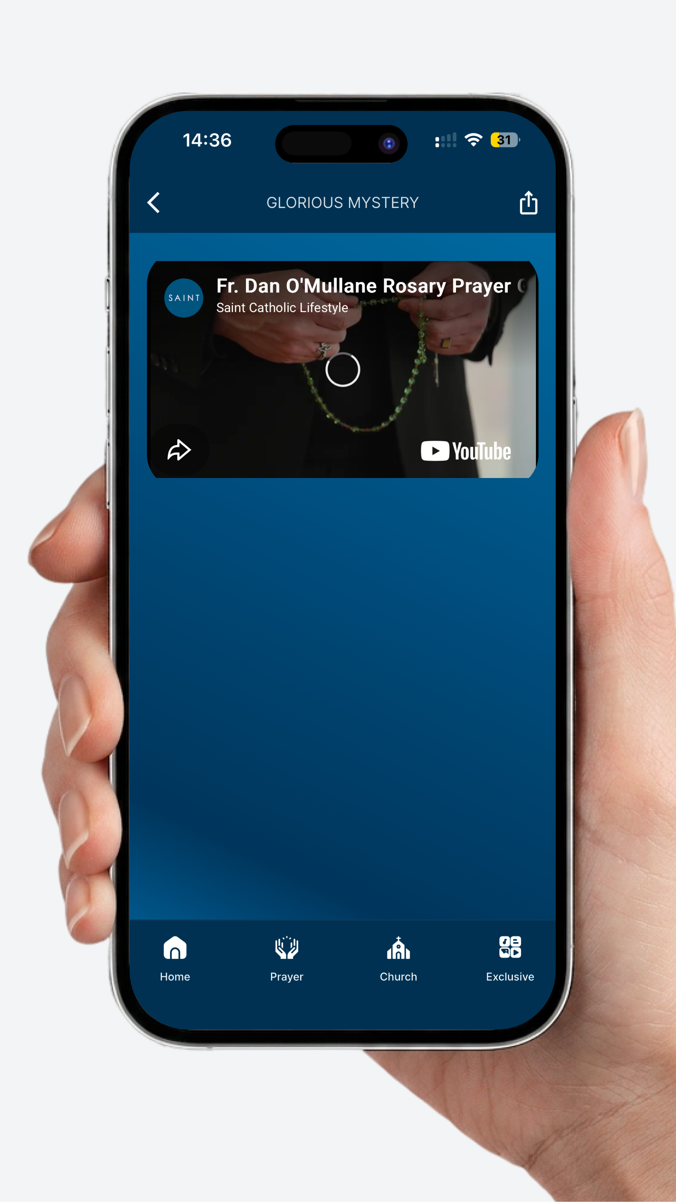 A person holding a smartphone that displays a prayer app called Glorious Mystery, showing a video titled 'Fr. Dan O'Mullane Rosary Prayer' with a rosary and a church icon at the bottom navigation menu.
