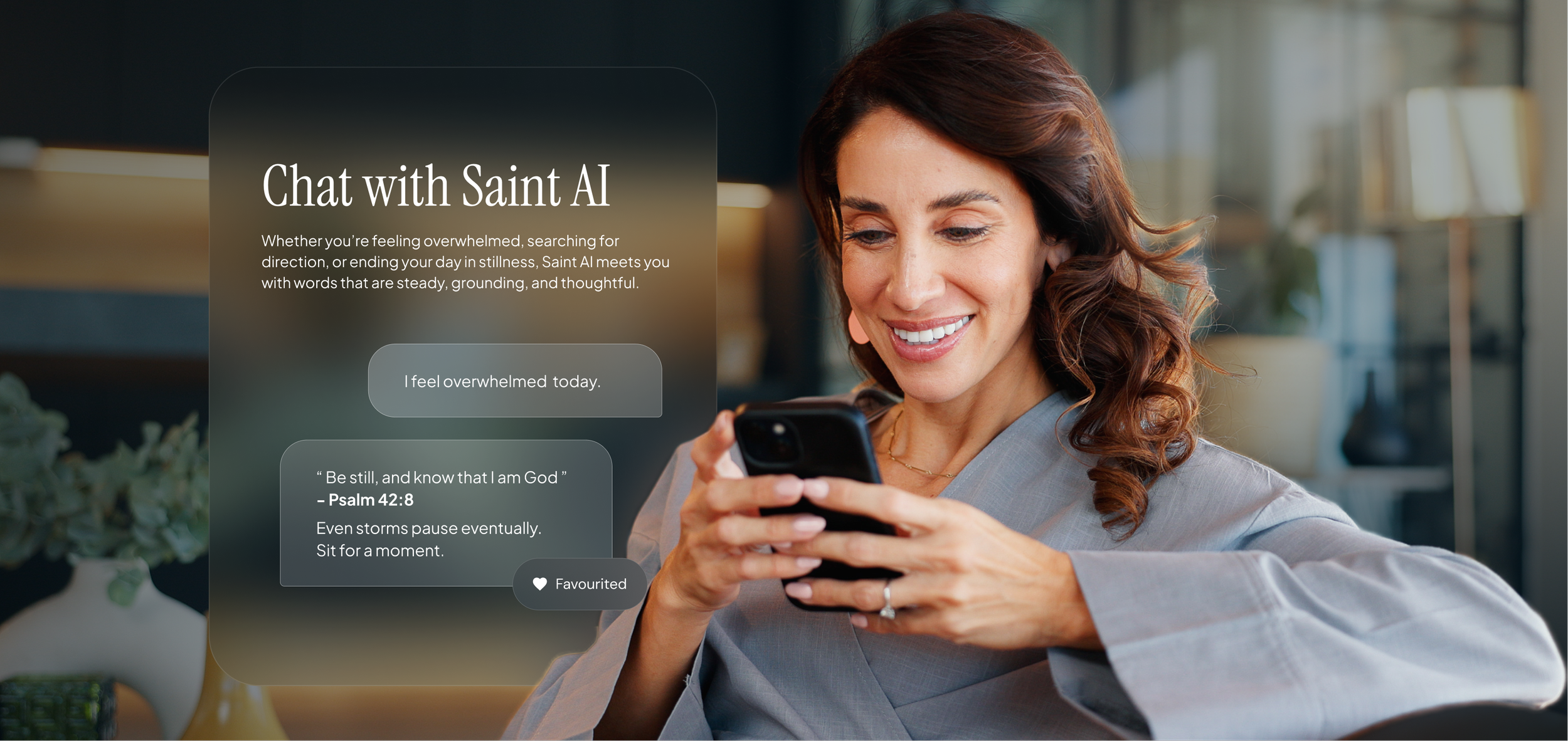 A woman with brown, curly hair smiling and looking at her smartphone in a modern, well-lit office or cafe setting.