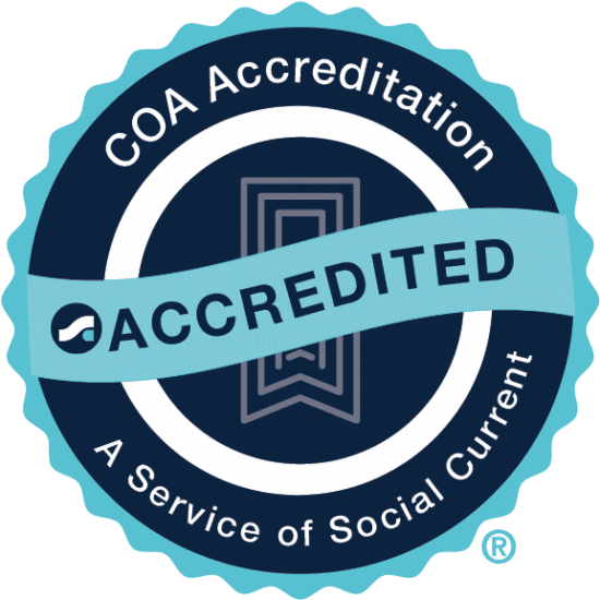 Seal indicating COA accreditation with a ribbon labeled 'Accredited' and the text 'A Service of Social Current' surrounding the design.