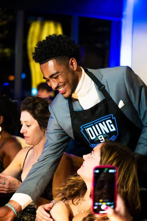 Image of Bryce Serving at Sneaker Ball