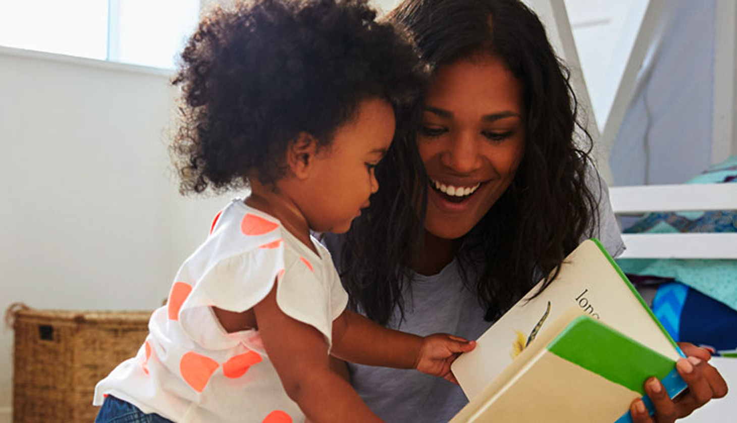 A woman and young child read together, representing continued support for families after completing residential care.