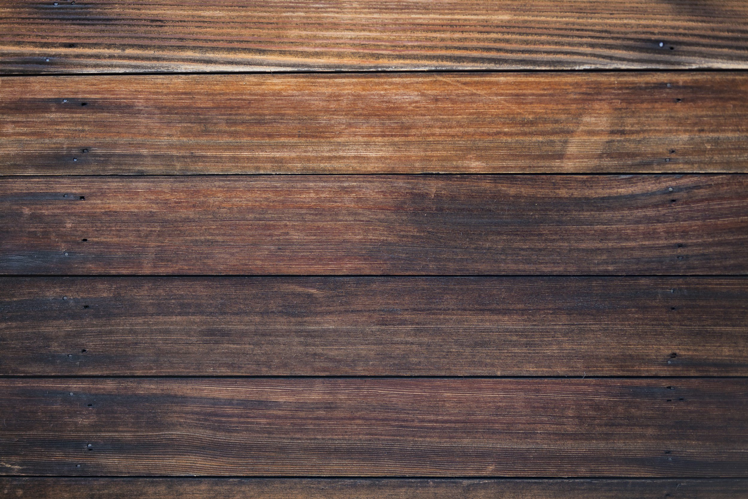 Close-up view of wooden planks with visible wood grain and small nails.