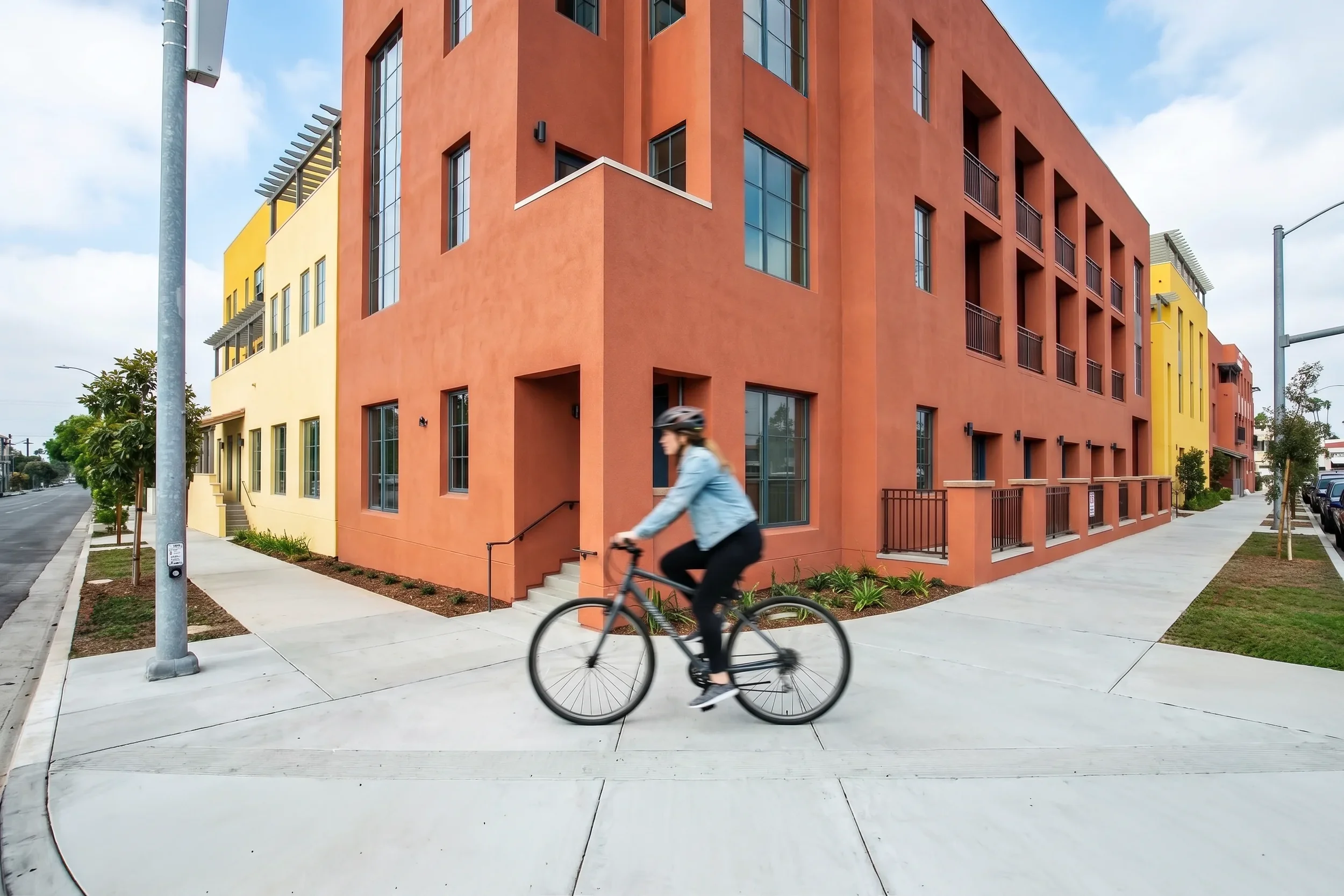 Woman riding bike in front of Walnut Crossing Pasadena at 1878 East Walnut Street in Pasadena, CA