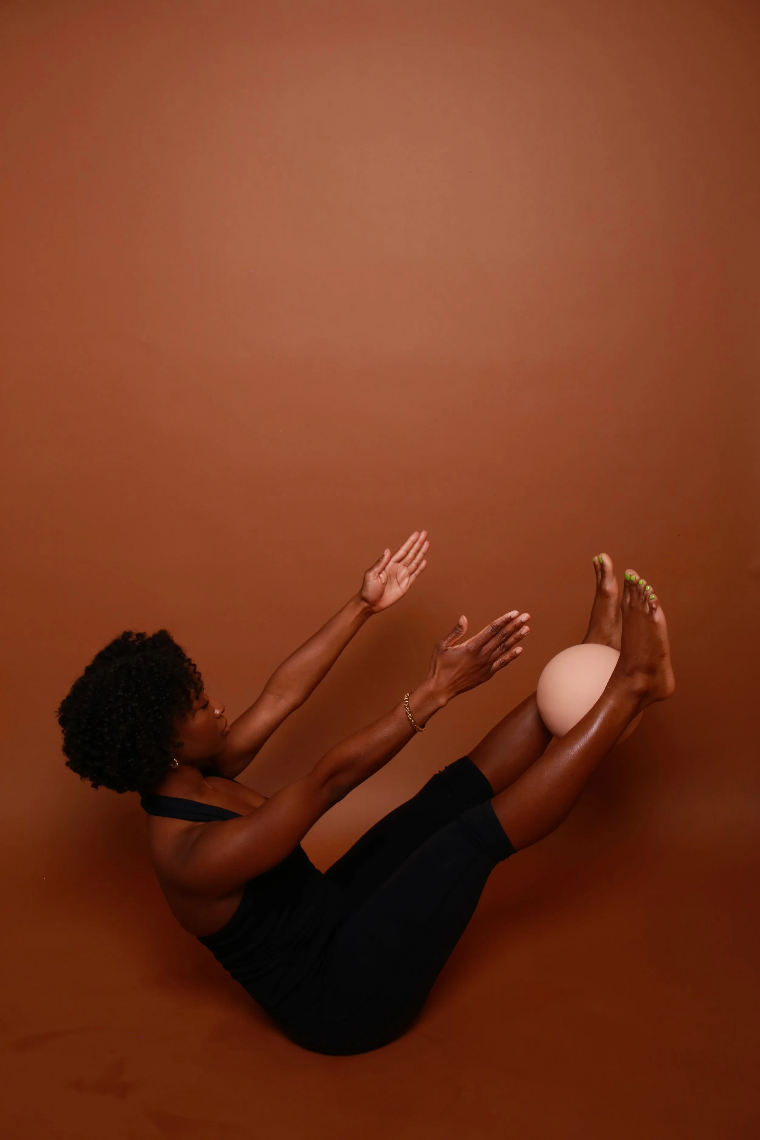 Black woman doing mat pilates, teaser