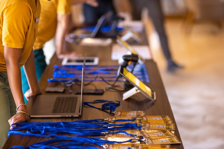 Name badges displayed on a conference registration table.