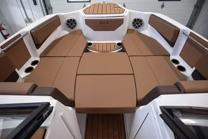 Interior view of a boat with brown and white seating and a central brown table.