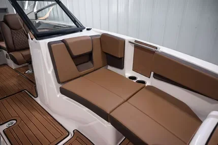 Boat's seating area with brown cushioned seats and a white interior surrounding the seats.