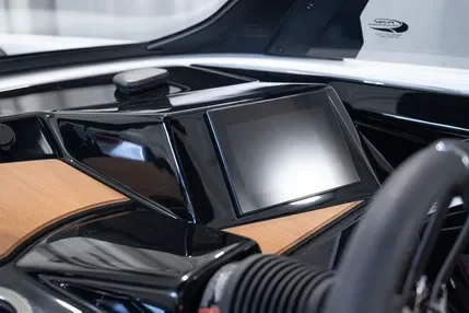 Car dashboard with a central touchscreen display and wooden trim.