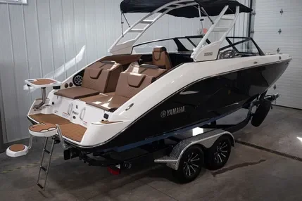 White and black Yamaha speedboat on a trailer inside a garage