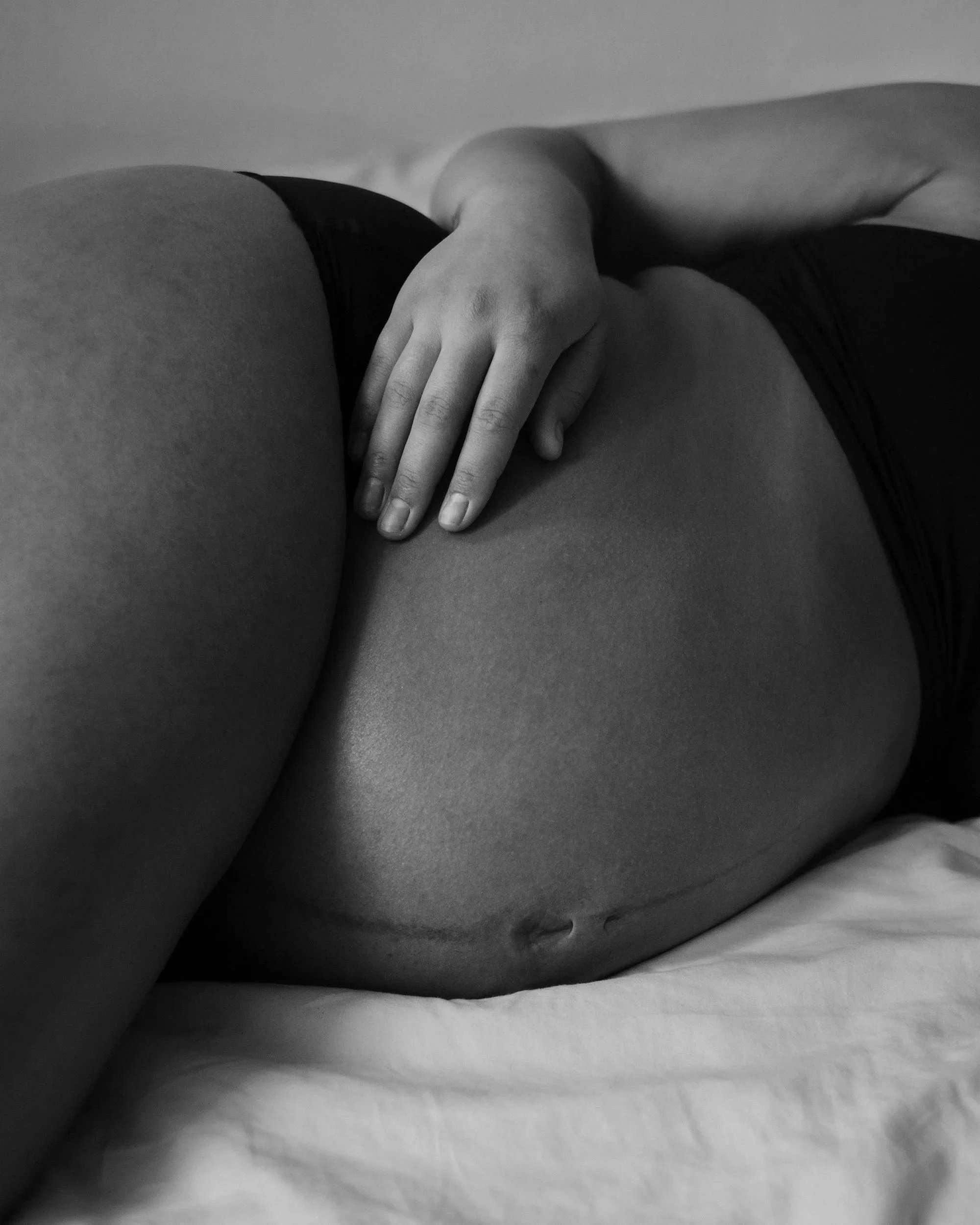 pregnant belly cradled by mother
