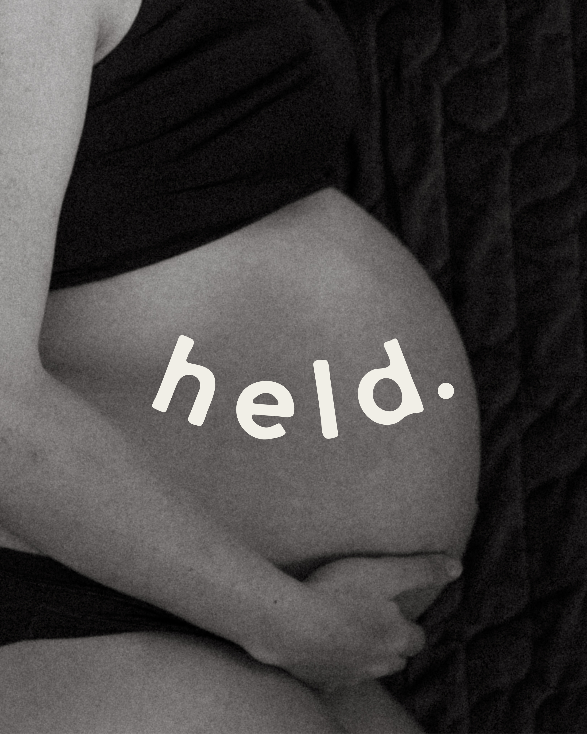 A close-up shot of a person's torso and arm, with the person holding their stomach, in black and white. The word 'held.' is written across the image.