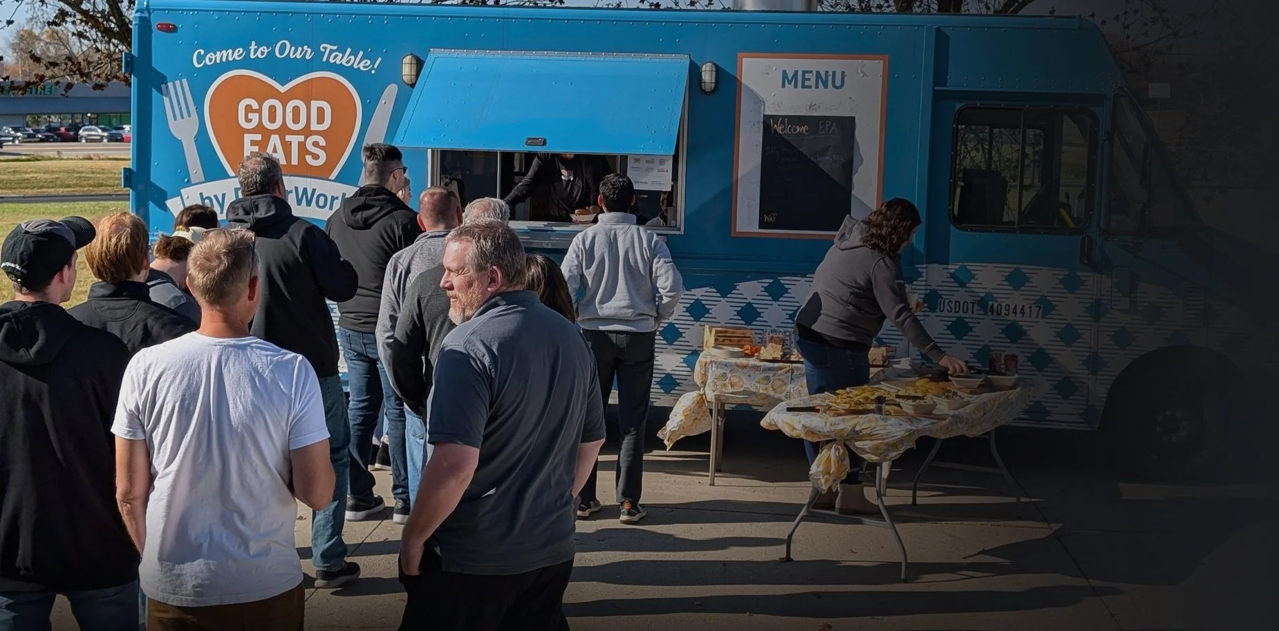 EPA Audio Visual team members gathered outside at a company event featuring the Good Eats food truck.