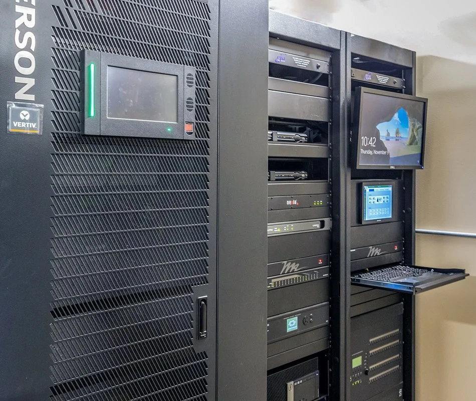 Audiovisual equipment racks at Crow Wing County Public Safety Dispatch Center featuring integrated video distribution, system controls, and equipment supporting emergency communications.