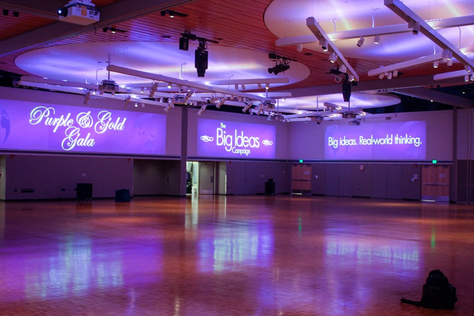 MSU Mankato Centennial Student Union Ballroom illuminated with purple lighting and large-scale projected graphics across multiple walls.