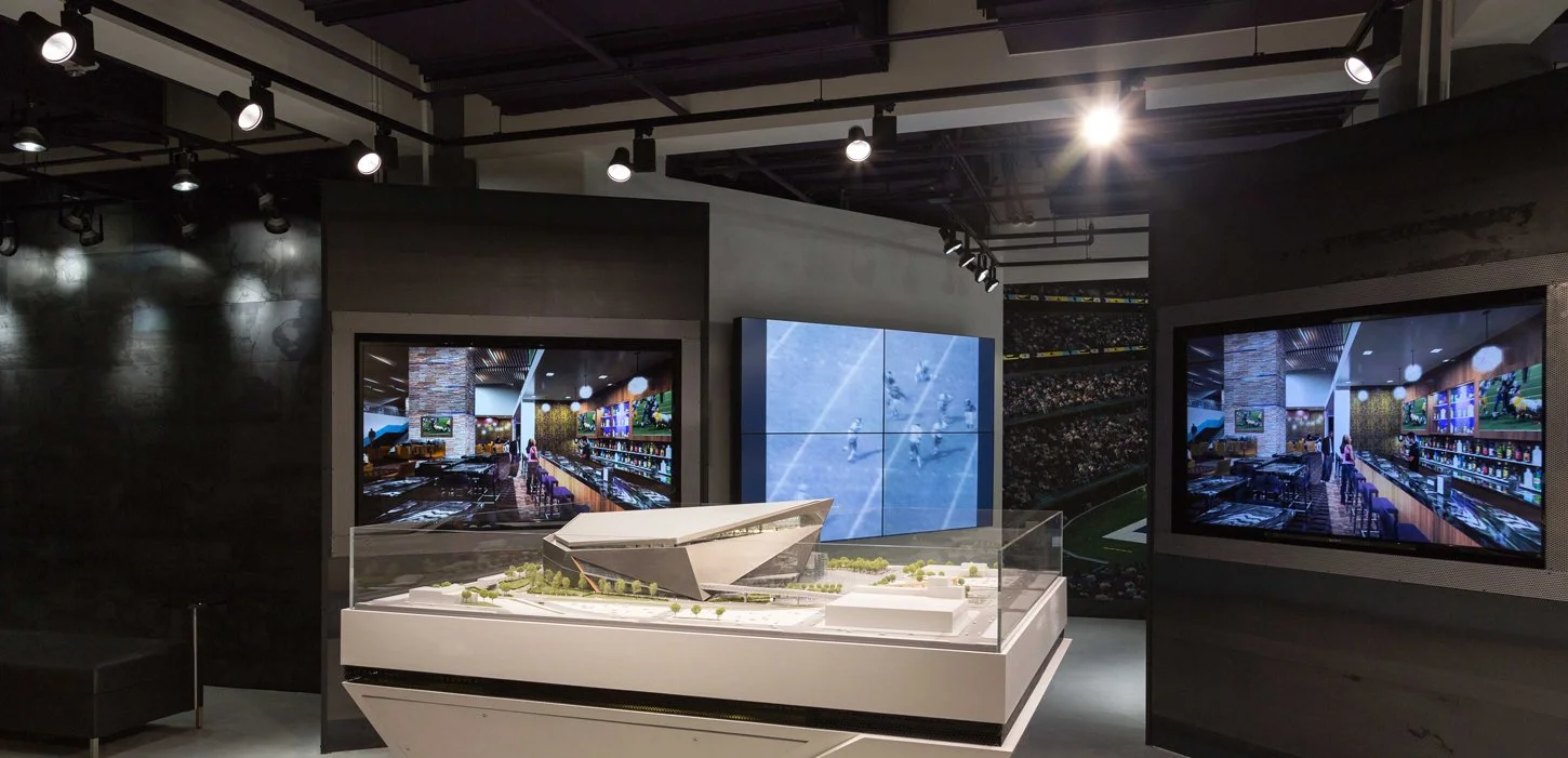 Minnesota Vikings U.S. Bank Stadium Preview Center featuring interactive video walls, digital displays, and a stadium model.