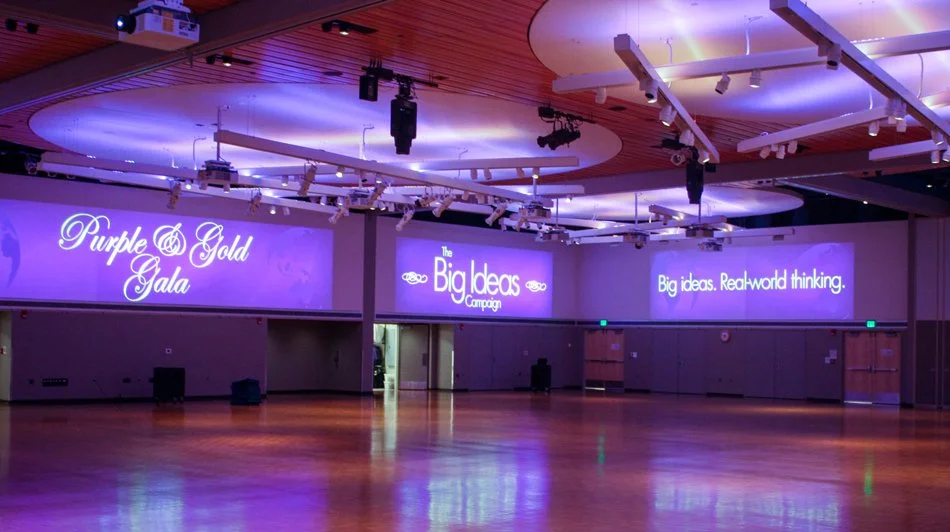 Minnesota State University Mankato Centennial Student Union Ballroom featuring large-scale projection displays and purple event lighting.