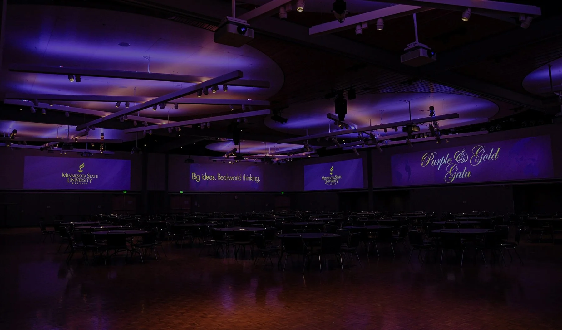 Minnesota State University Mankato ballroom featuring immersive projection displays, purple event lighting, and audiovisual technology for large-scale events.