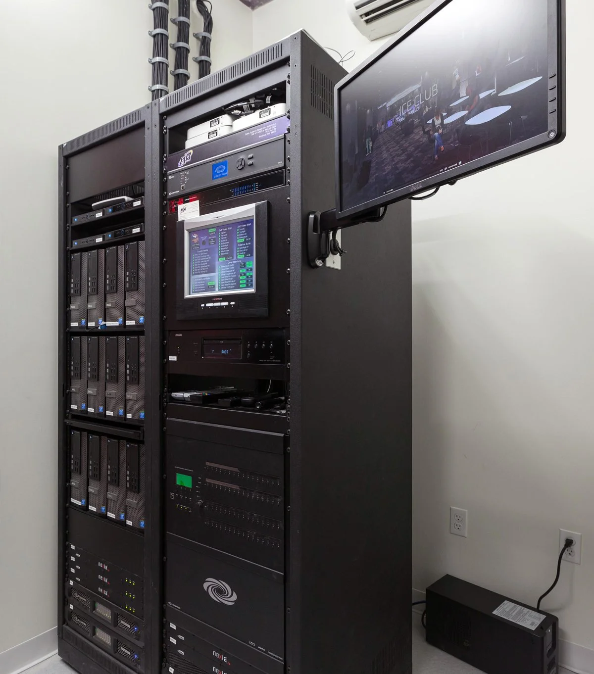 Professional audiovisual equipment rack with integrated control touchscreen and monitor at the Minnesota Vikings U.S. Bank Stadium Preview Center.