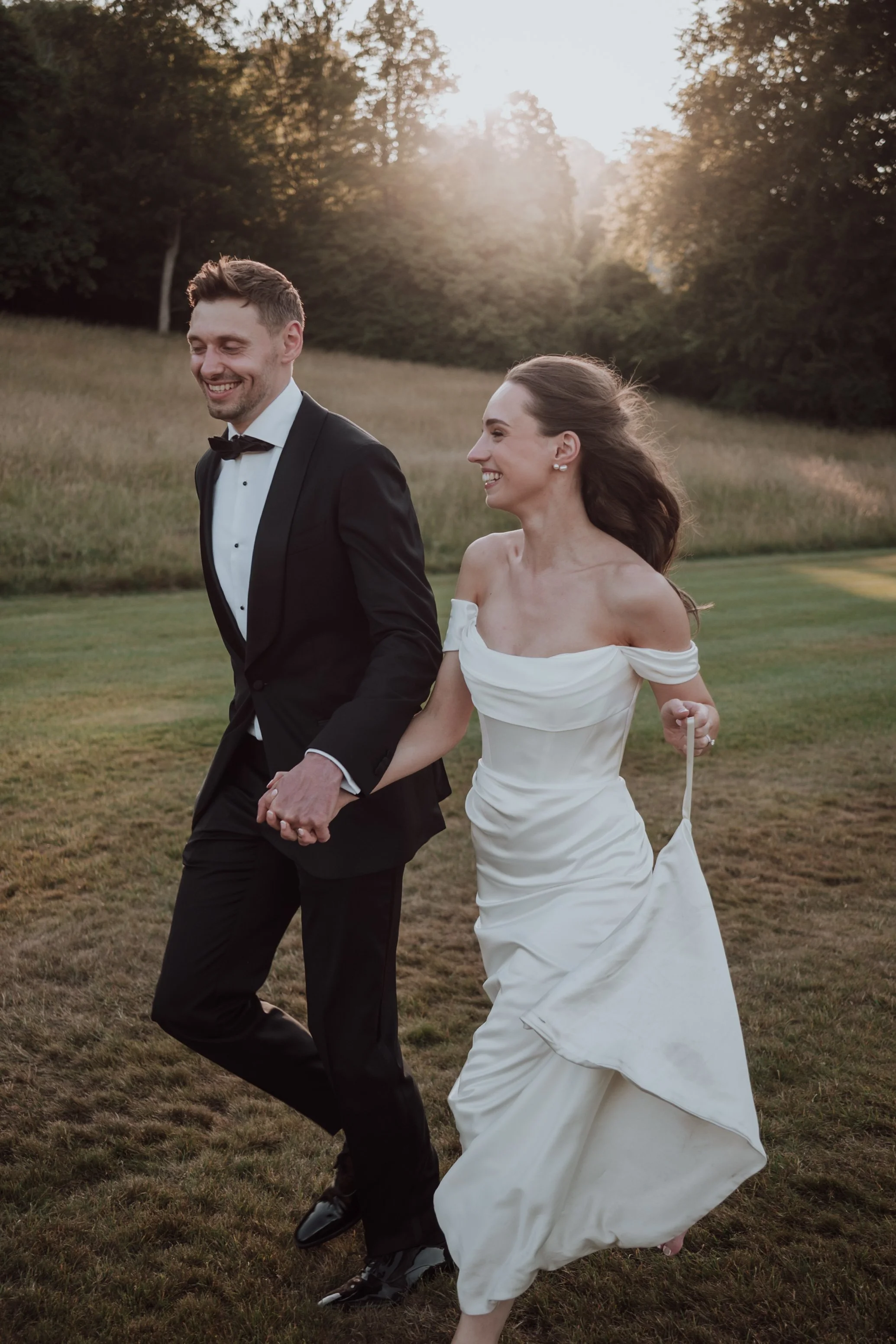 Bride and groom walking at sunset