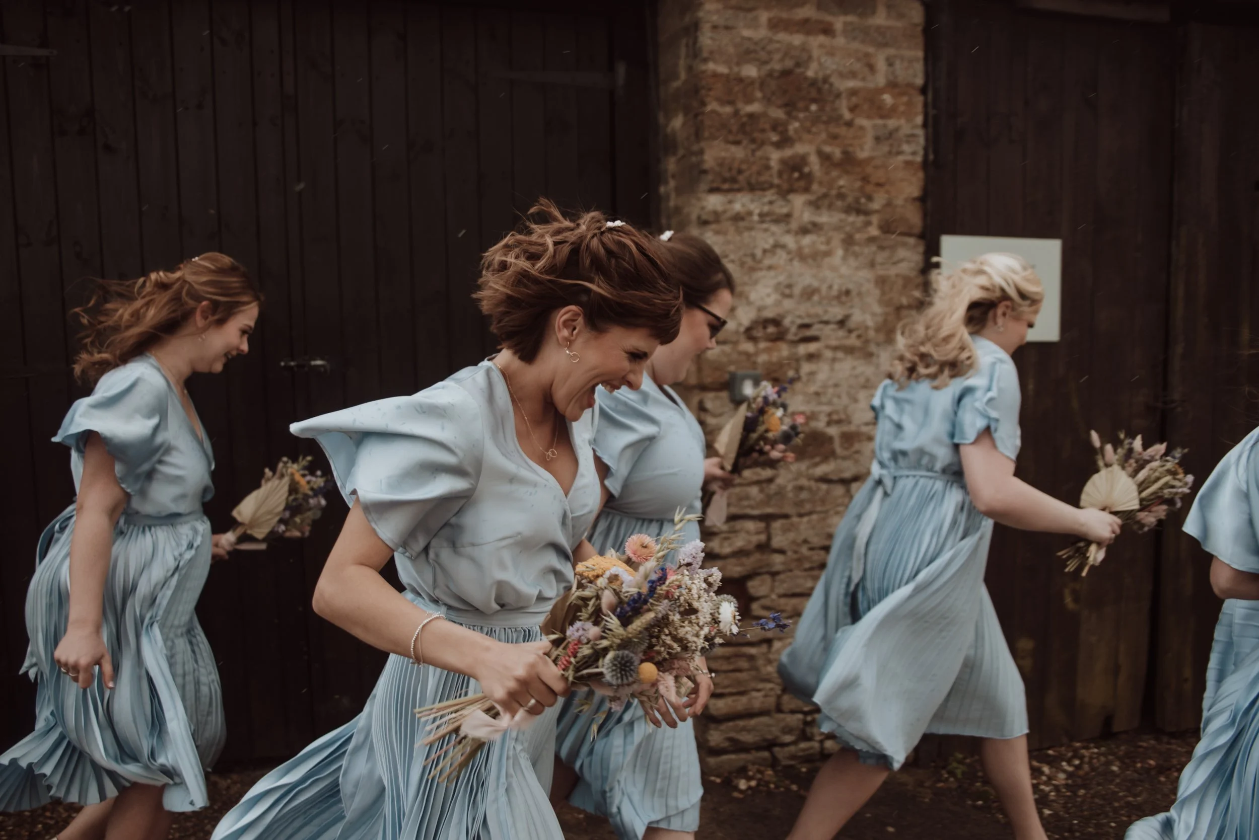 Bridesmaids running during wedding celebration
