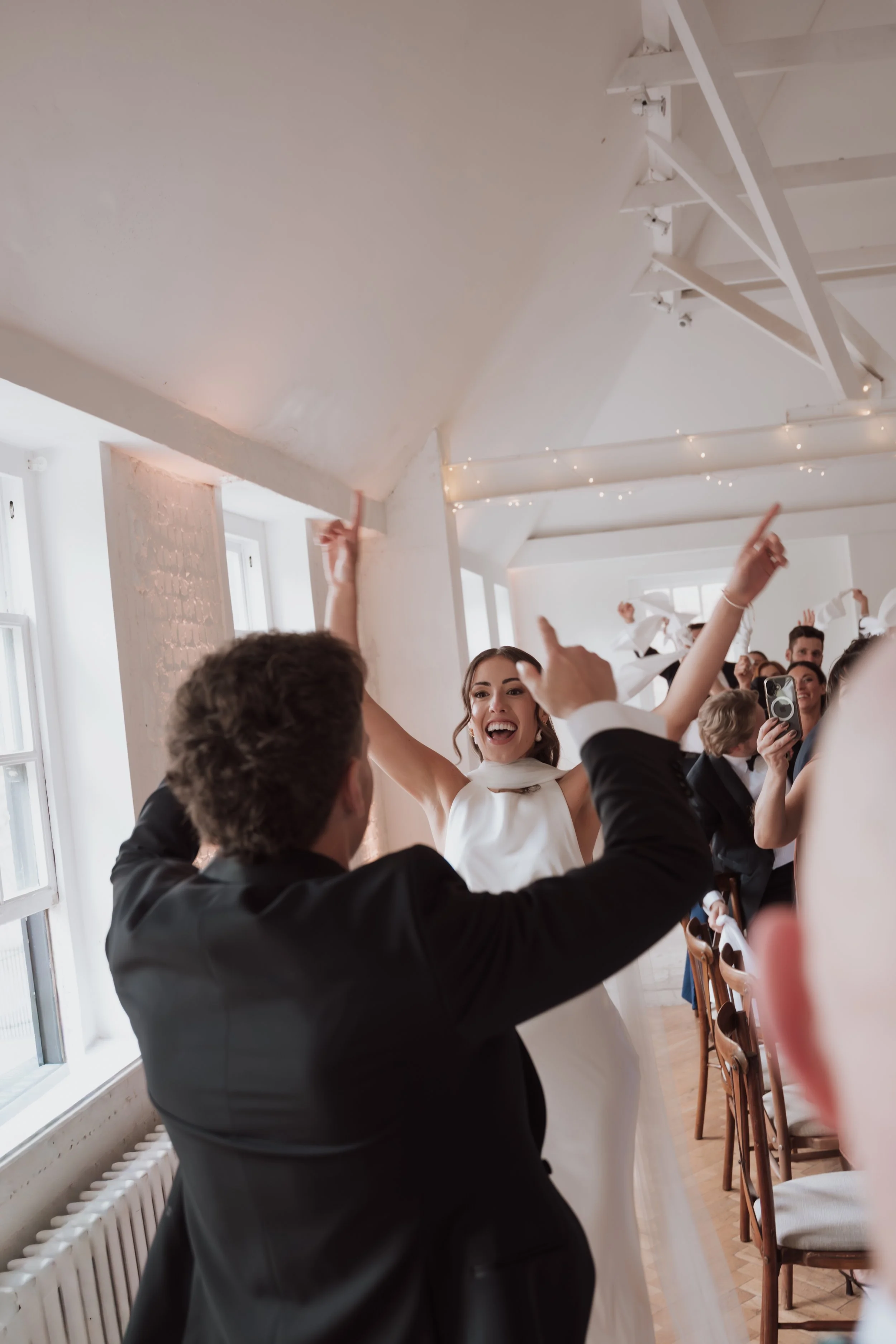 Candid wedding reception entrance celebration