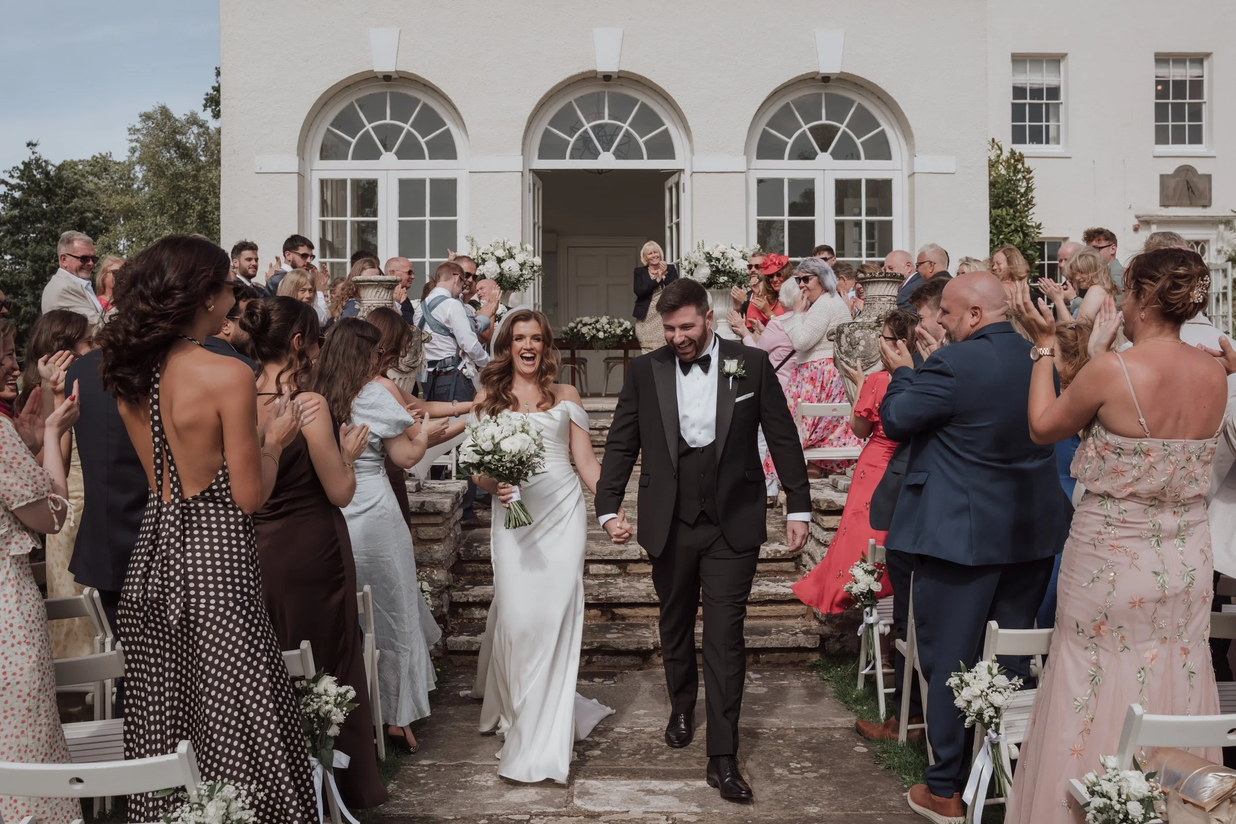 Bride and groom walking down aisle after ceremony