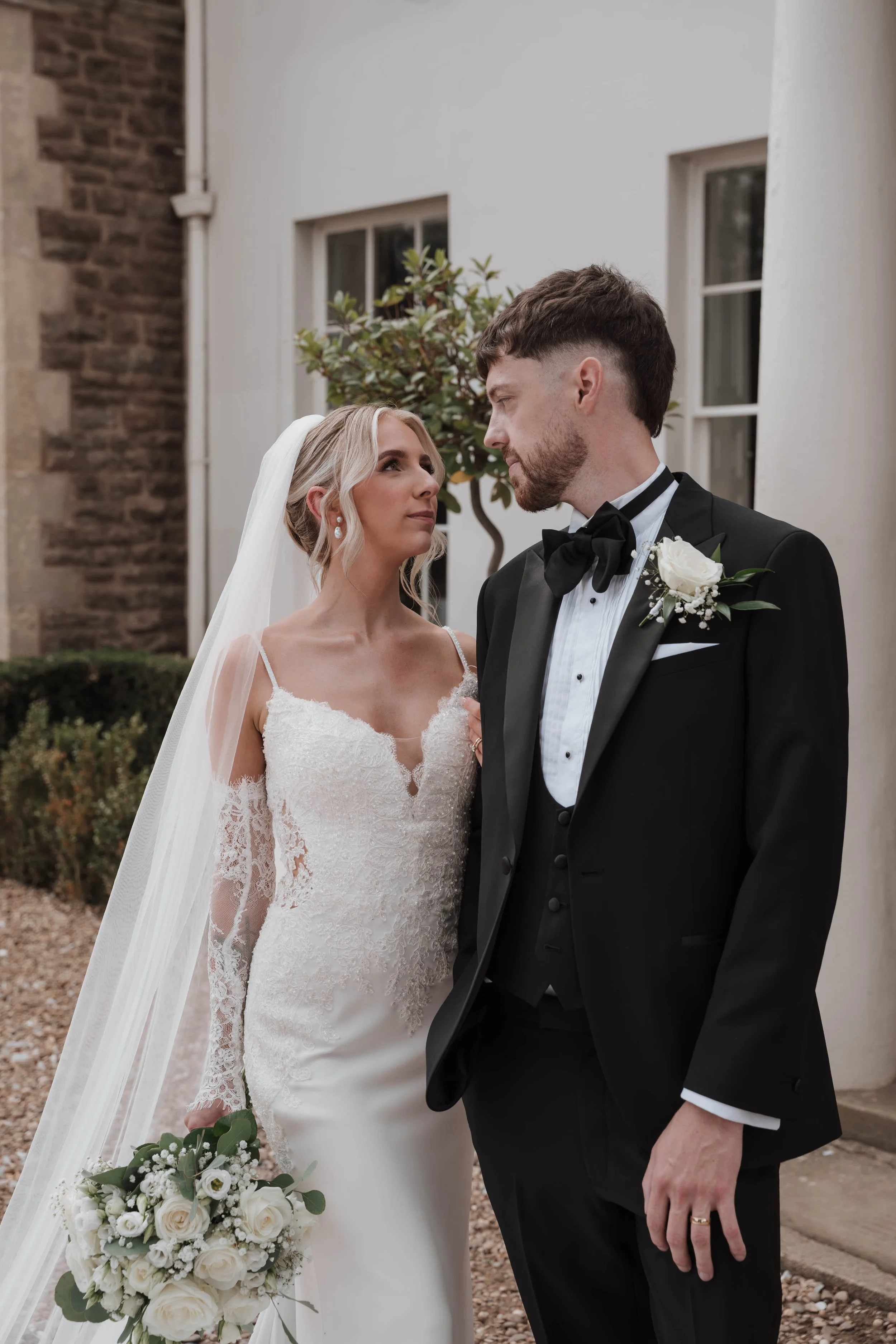 Bride and groom outside elegant wedding venue