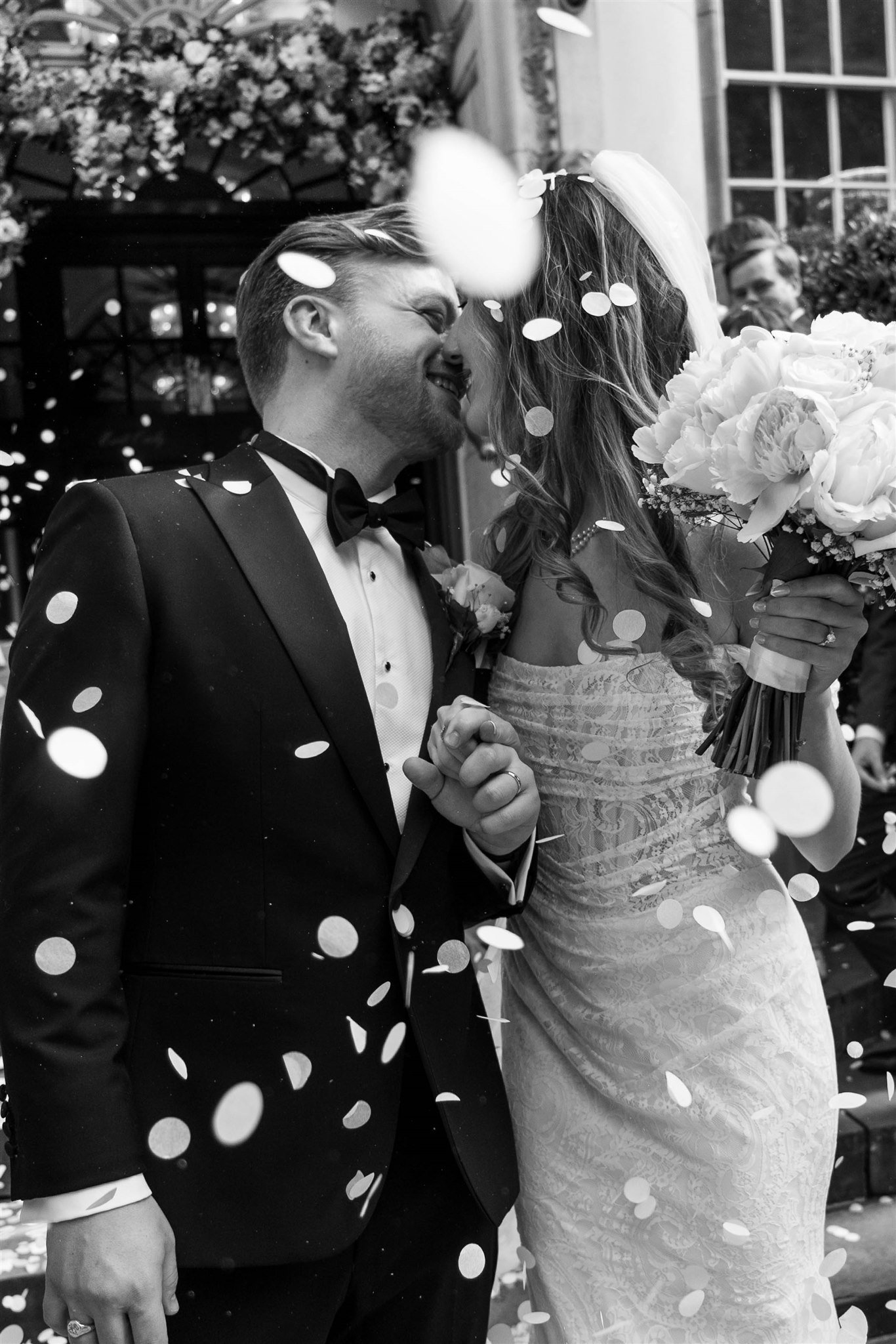 Black and white confetti wedding kiss