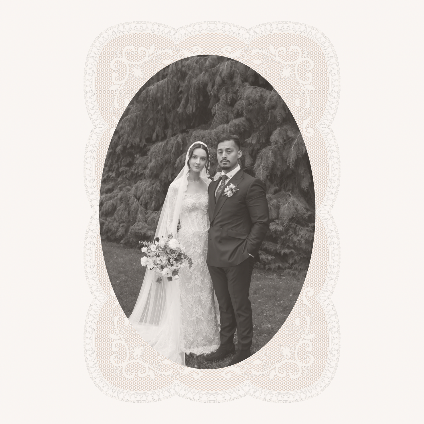 Black and white wedding photo of a bride and groom standing outdoors in front of trees. The bride is holding a bouquet of flowers and wearing a lace wedding dress with a veil. The groom is dressed in a dark suit with a boutonniere, and has his hand in his pocket.