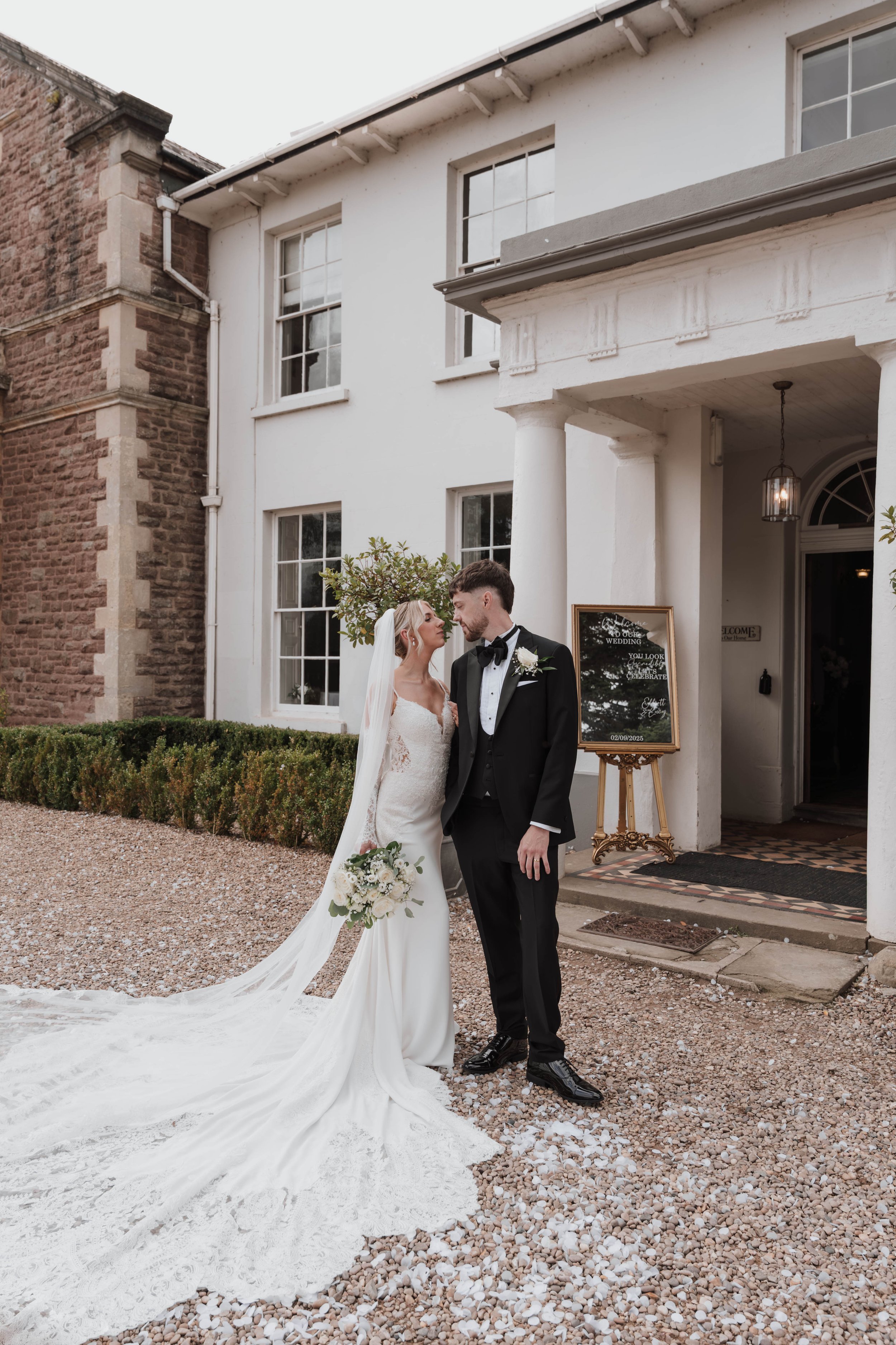 Bride and groom outside elegant wedding venue