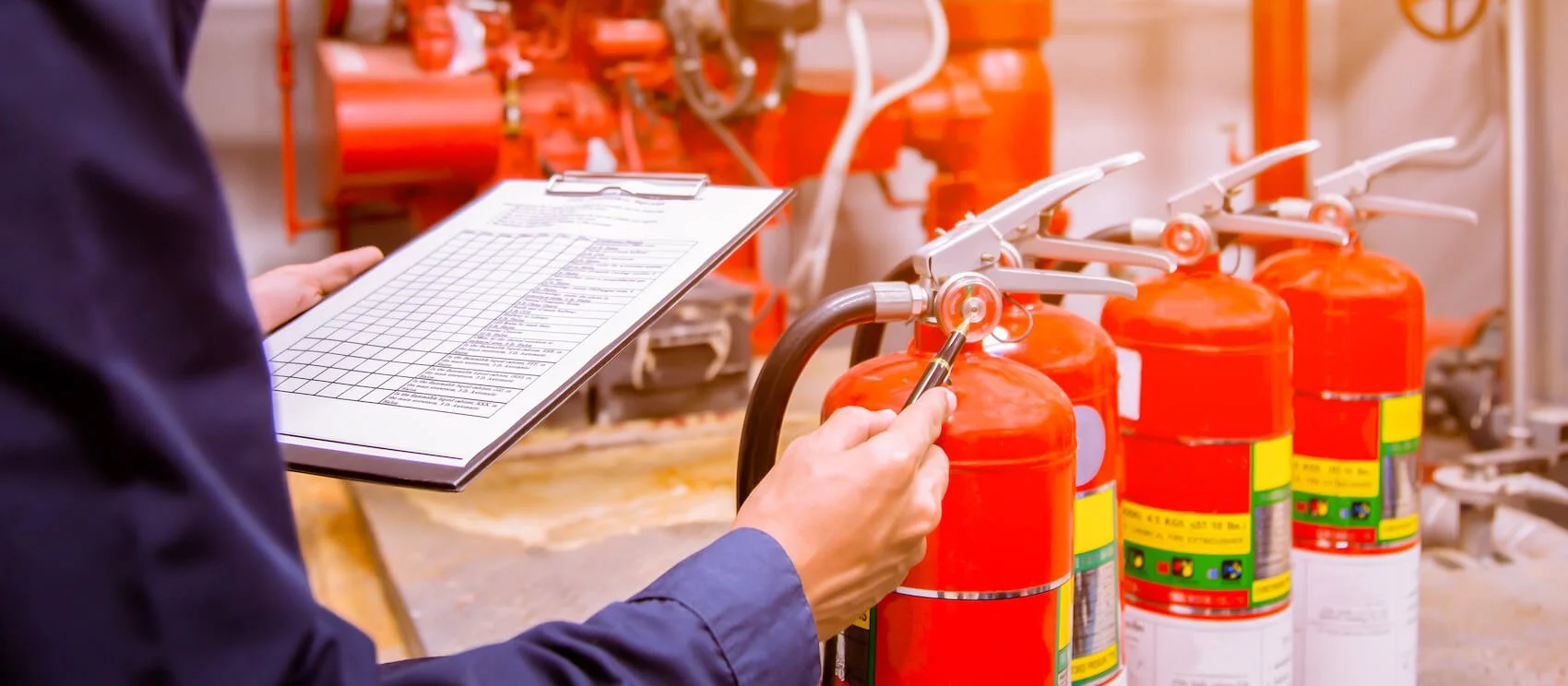Engineer with a clipboard checking Industrial fire control system