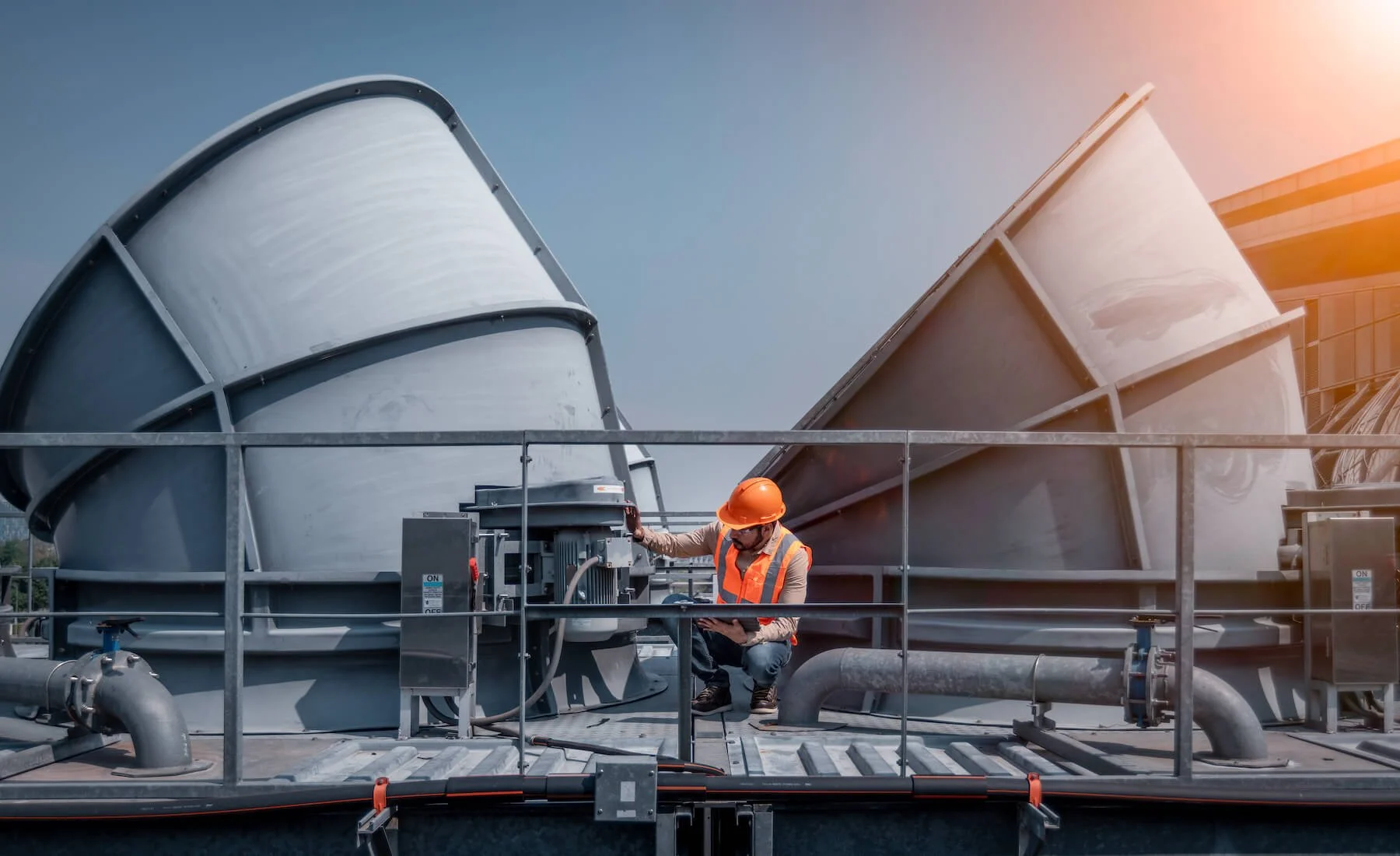 mechanical engineer on a roof checking the industry cooling tower HVAC system
