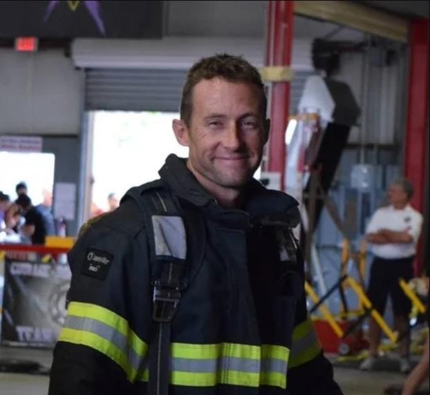 James Geering in firefighter turnout gear inside a fire station.