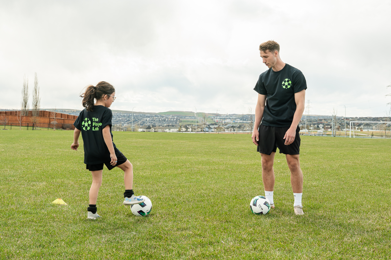 Young soccer player improving ball control and confidence with personalized coaching during a youth soccer training session in Calgary.