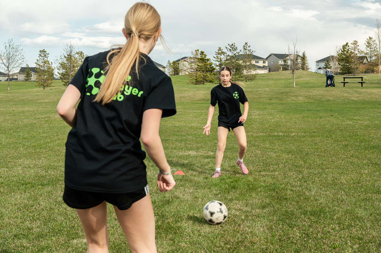 Youth soccer players developing passing, ball control, and confidence during a soccer training session in Calgary.