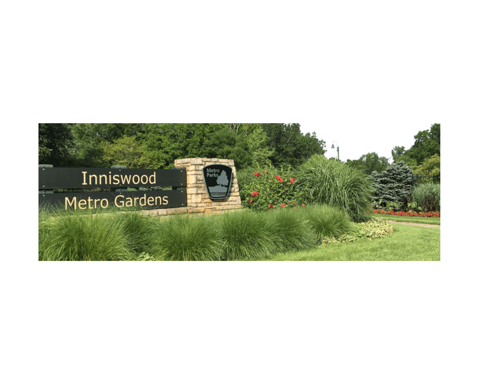 Entrance sign for Inniswood Metro Gardens with landscaping and greenery.