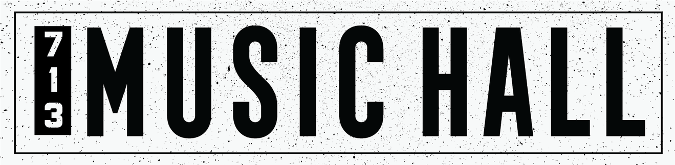 Sign with the text '123 MUSIC HALL' in bold black letters on a white background with black speckles.