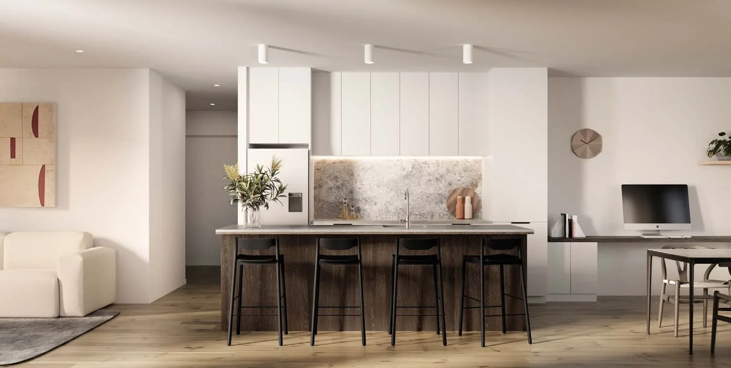 Modern open-concept living space with a kitchen island, bar stools, a white sofa, wall art, a desk with a computer, and decorative elements like a clock and artwork.