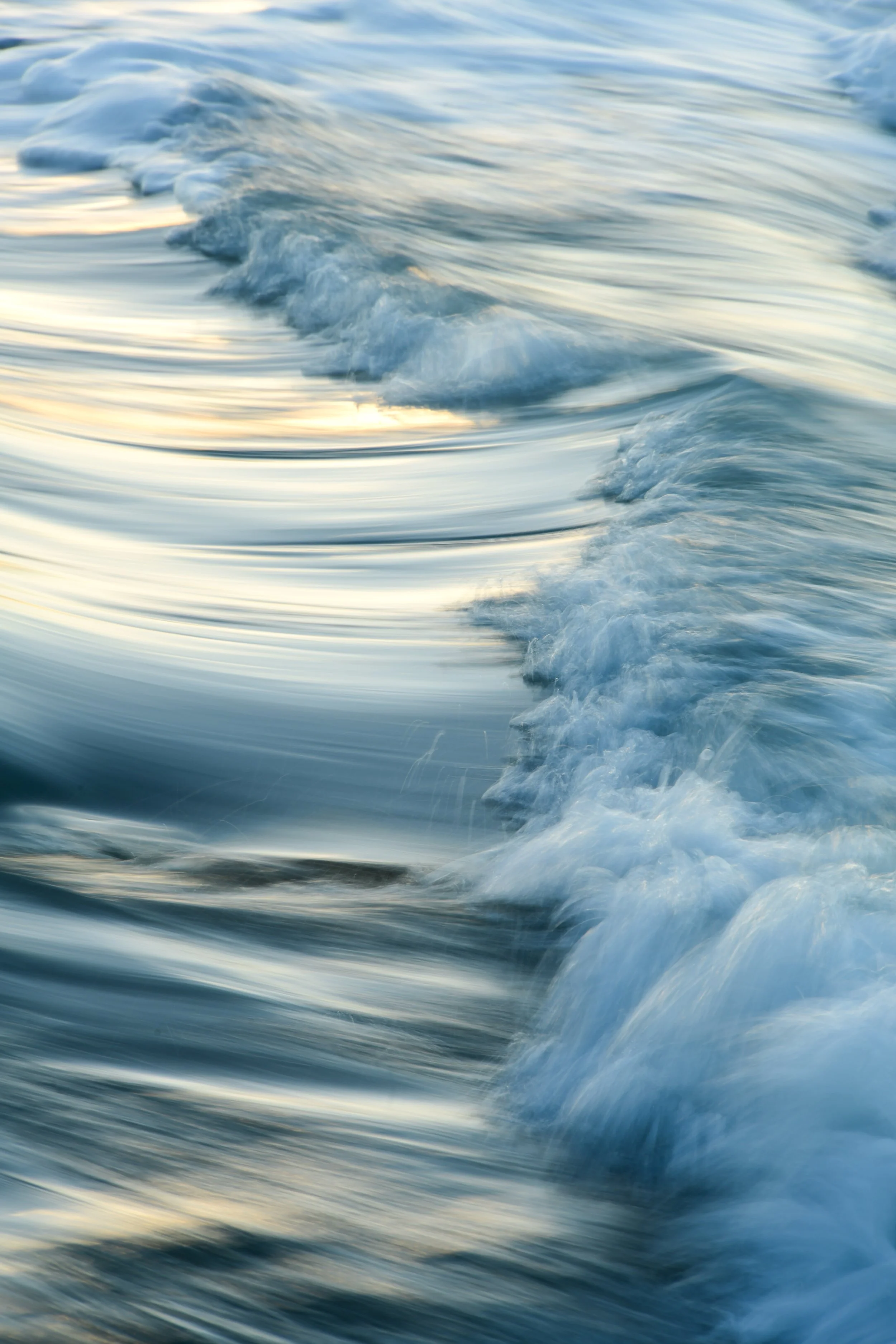 Blurred image of ocean waves at sunset or sunrise.