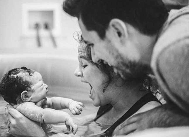 Happy HypnoBirthing couple giving birth, Oahu, Hawaii