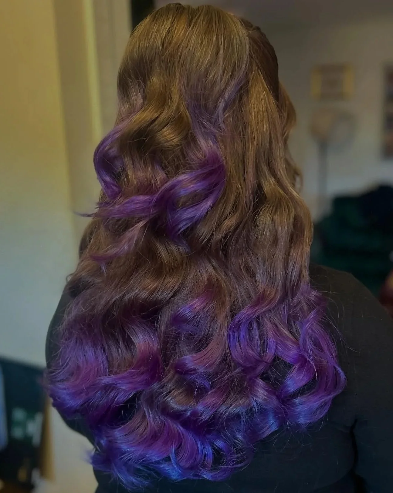 Hair with brown transitioning into purple curls with a gradient effect