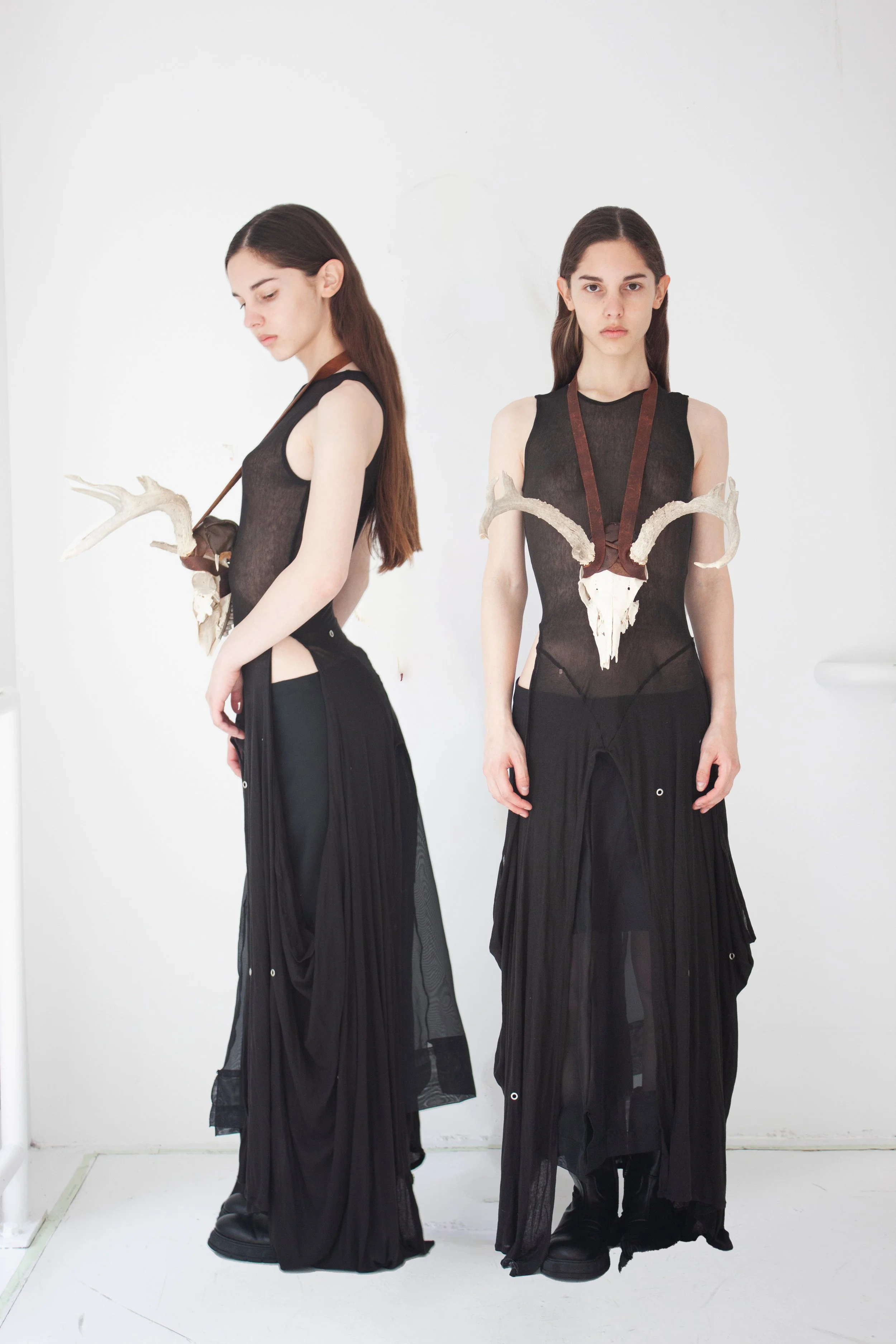 Lightweight knit dress, repurposed synthetic organza pencil skirt, and a deer skull neckpiece sourced from New Jersey woods with leather scraps. 